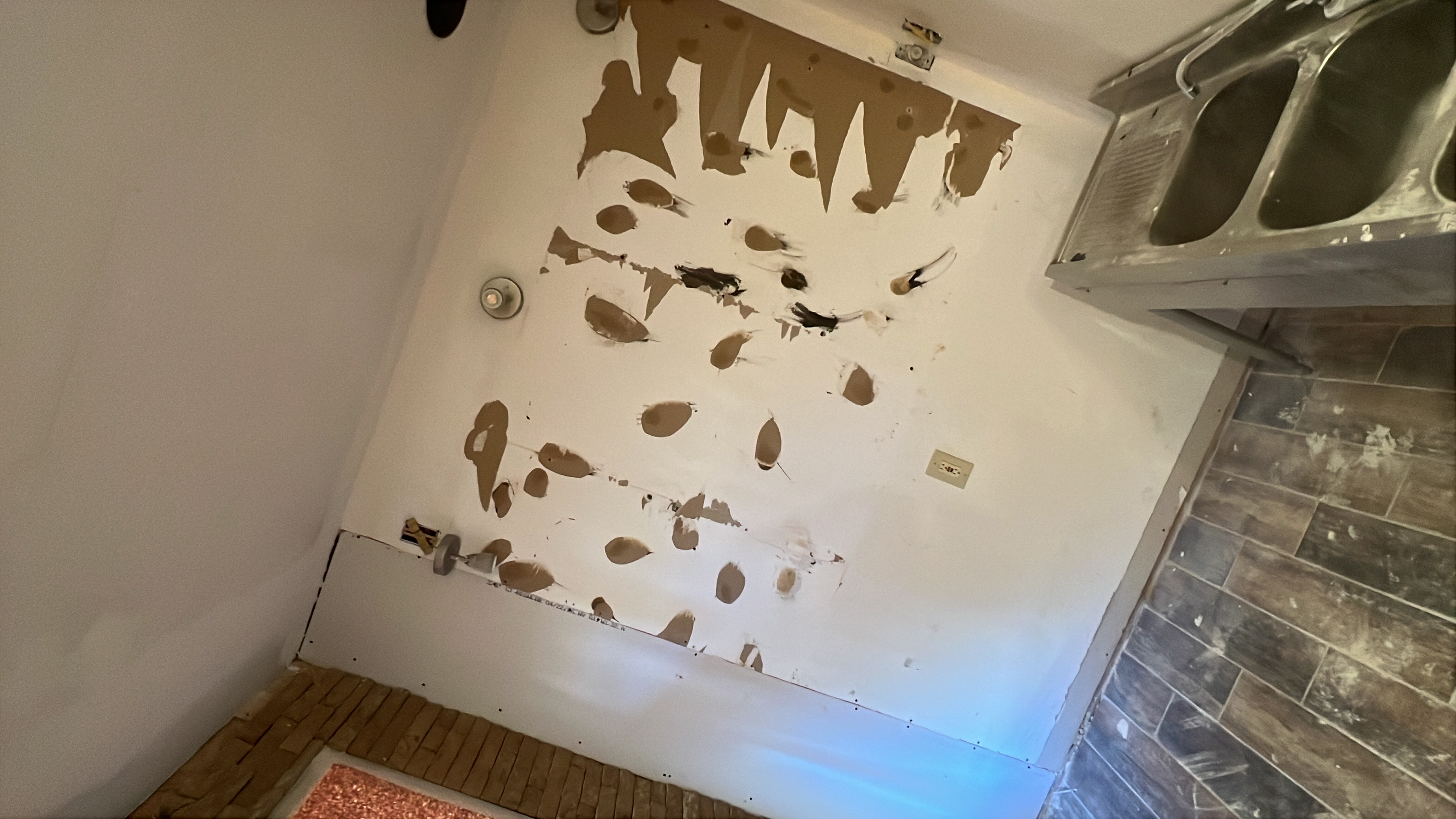 Damaged drywall wall prepared for repair