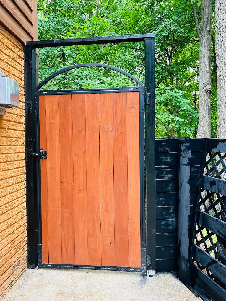 Wood gate with black metal frame